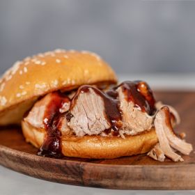 Canned Pork on a Bun with Bbq Sauce on a Plate